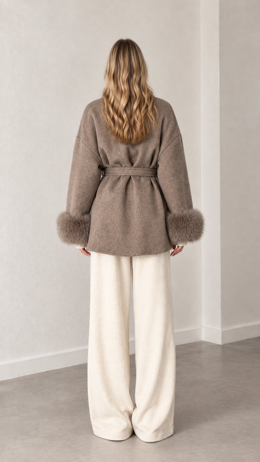 Back view of model wearing belted taupe wrap coat