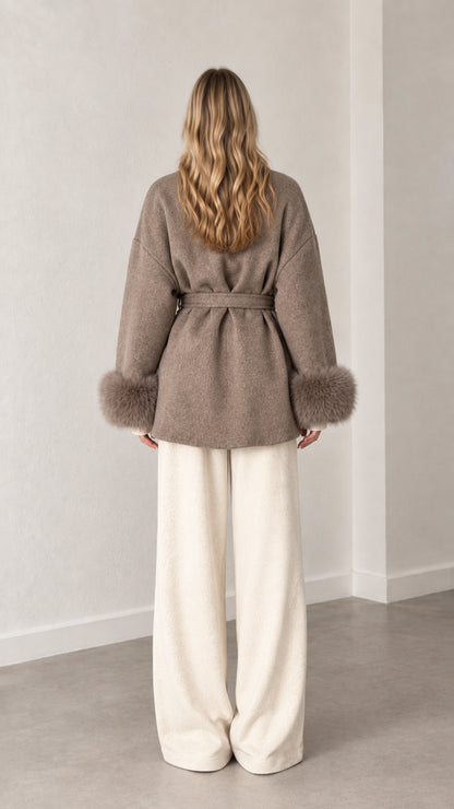 Back view of model wearing belted taupe wrap coat