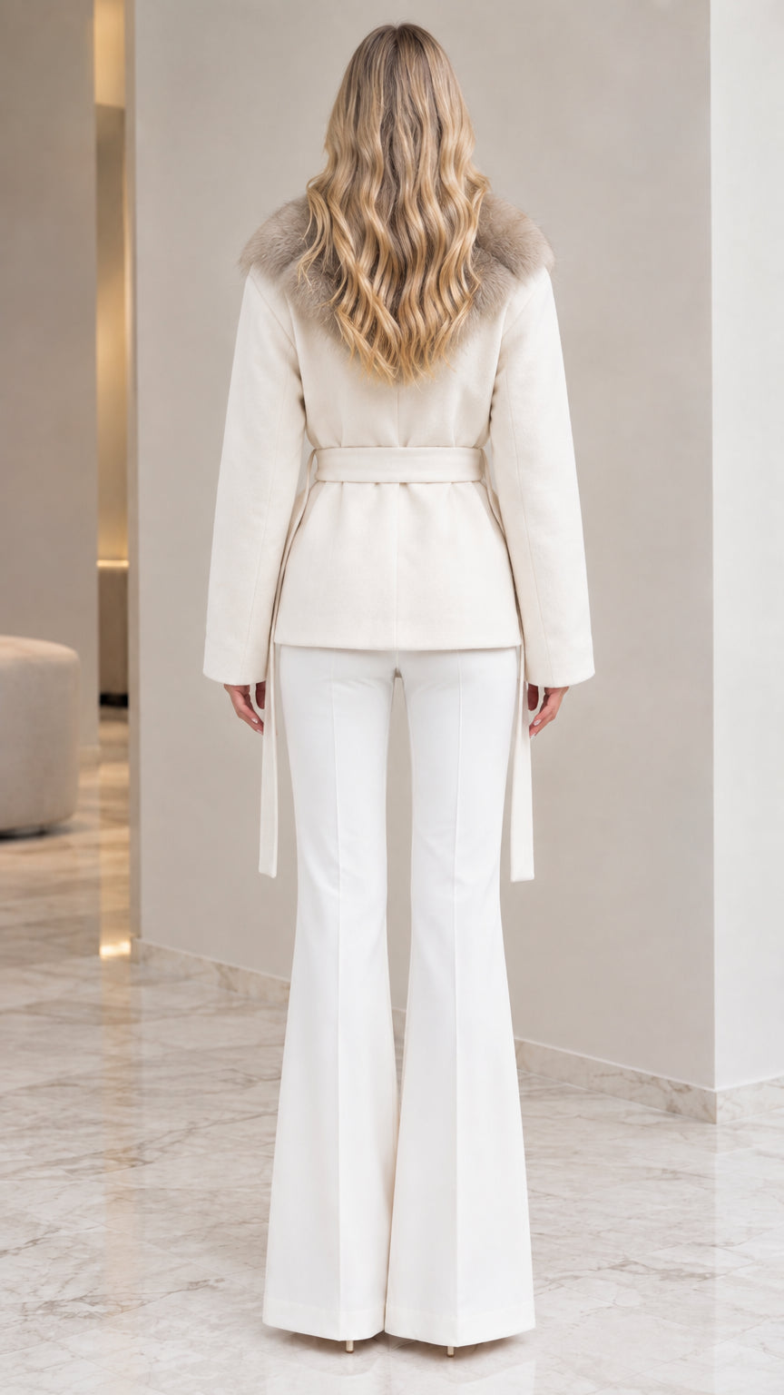 Back view of model in ivory belted wrap jacket