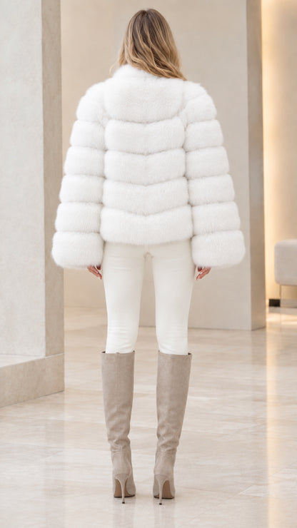 Rear view of woman wearing white horizontal banded faux fur winter jacket
