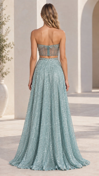 Back view of model wearing dusty blue two-piece glitter maxi evening gown