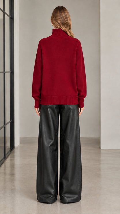 Back view of woman wearing burgundy high neck knit cardigan
