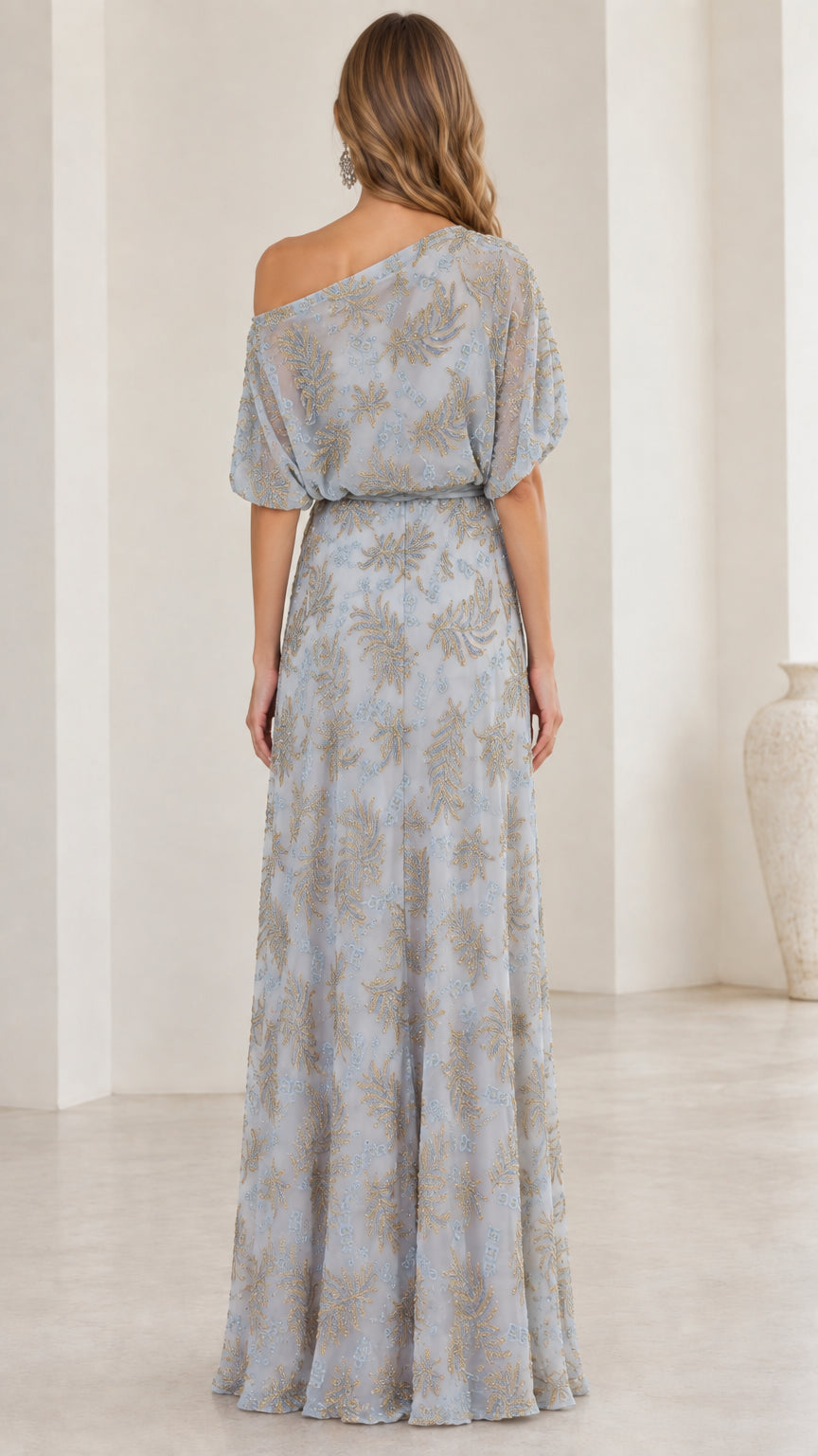 Back view of woman wearing slate blue one-shoulder maxi dress