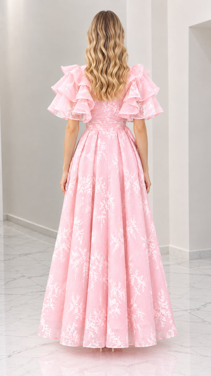 Back view of pink floral embroidered maxi dress with flutter sleeves and flowing skirt