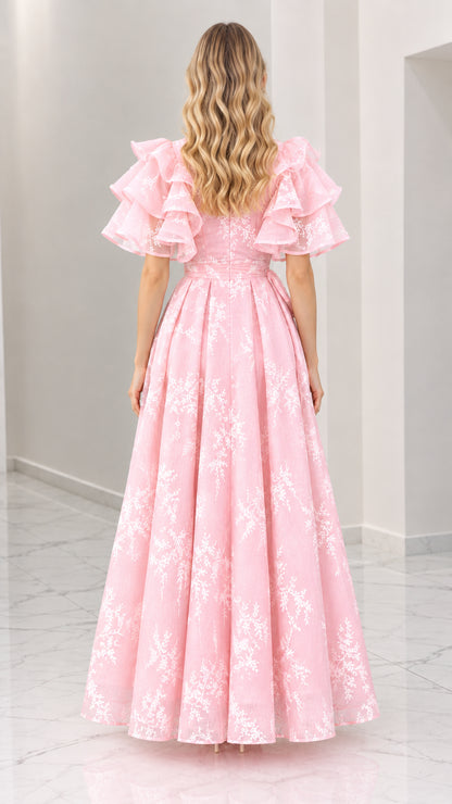 Back view of pink floral embroidered maxi dress with flutter sleeves and flowing skirt