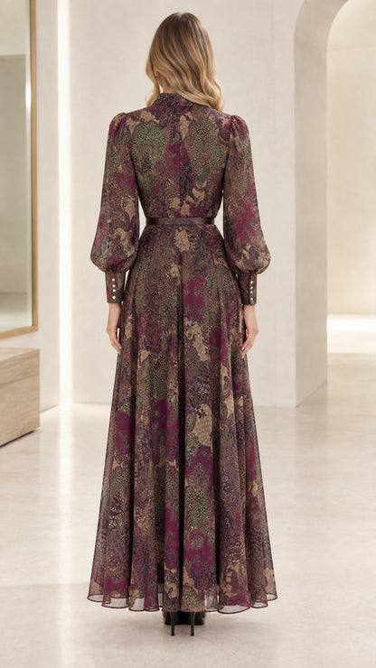 Back view of woman wearing flowing paisley printed maxi dress