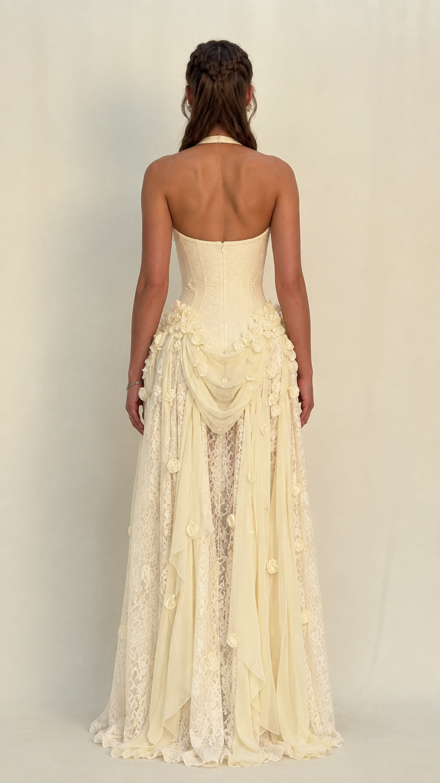 Back view of model in Champagne halter open-back evening gown with lace train