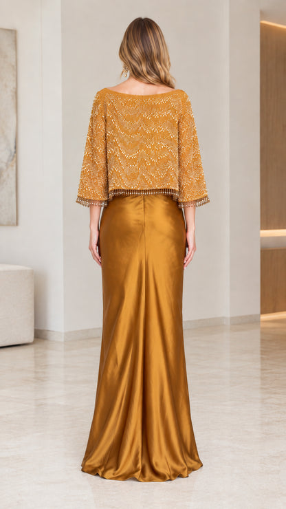 Back full-length view of the Gold satin formal gown with capelet