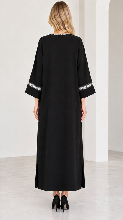 Back view of model in black pearl trim kaftan dress