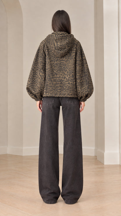 Back view of model wearing brown leopard print hooded jacket showcasing balloon sleeve volume