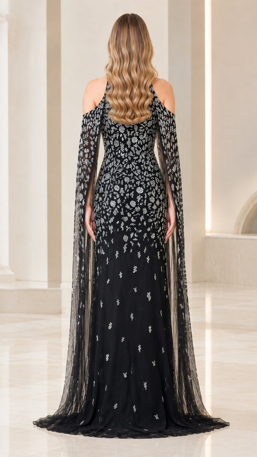 Back view of black floor-length formal dress featuring elegant cape overlay