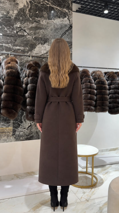 Back view of woman wearing a long tailored brown wool-blend coat