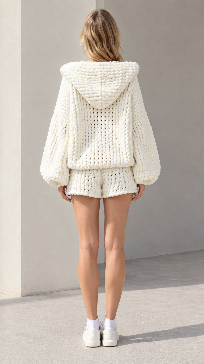 Back view of model showcasing the hood and texture of cream knit sweater set