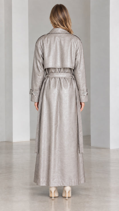 Back view of metallic silver maxi trench coat showing storm flap and belt