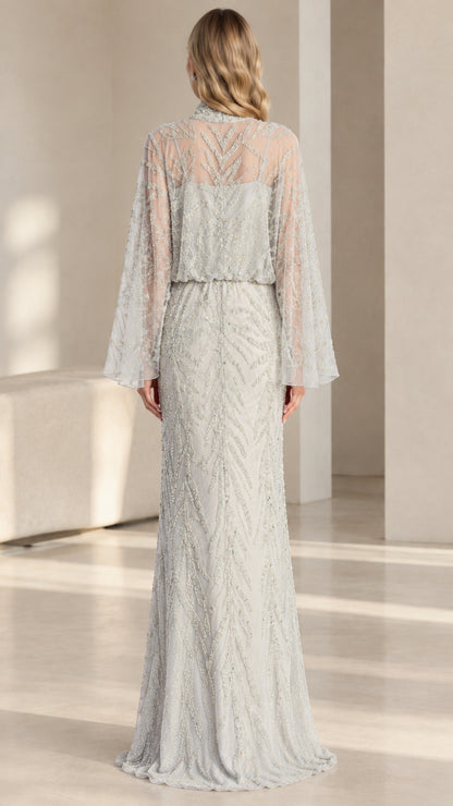 Back view of woman wearing silver floor-length embellished evening gown