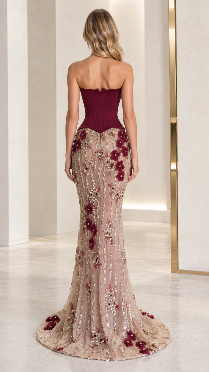 Back view of strapless burgundy mermaid gown showcasing corset back and floor-length train