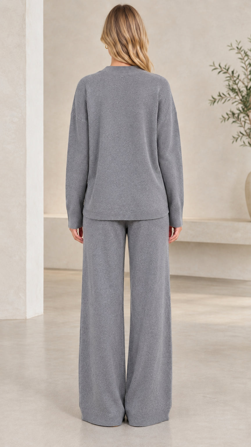 Back view of women's heather grey knit crewneck top and wide-leg trousers
