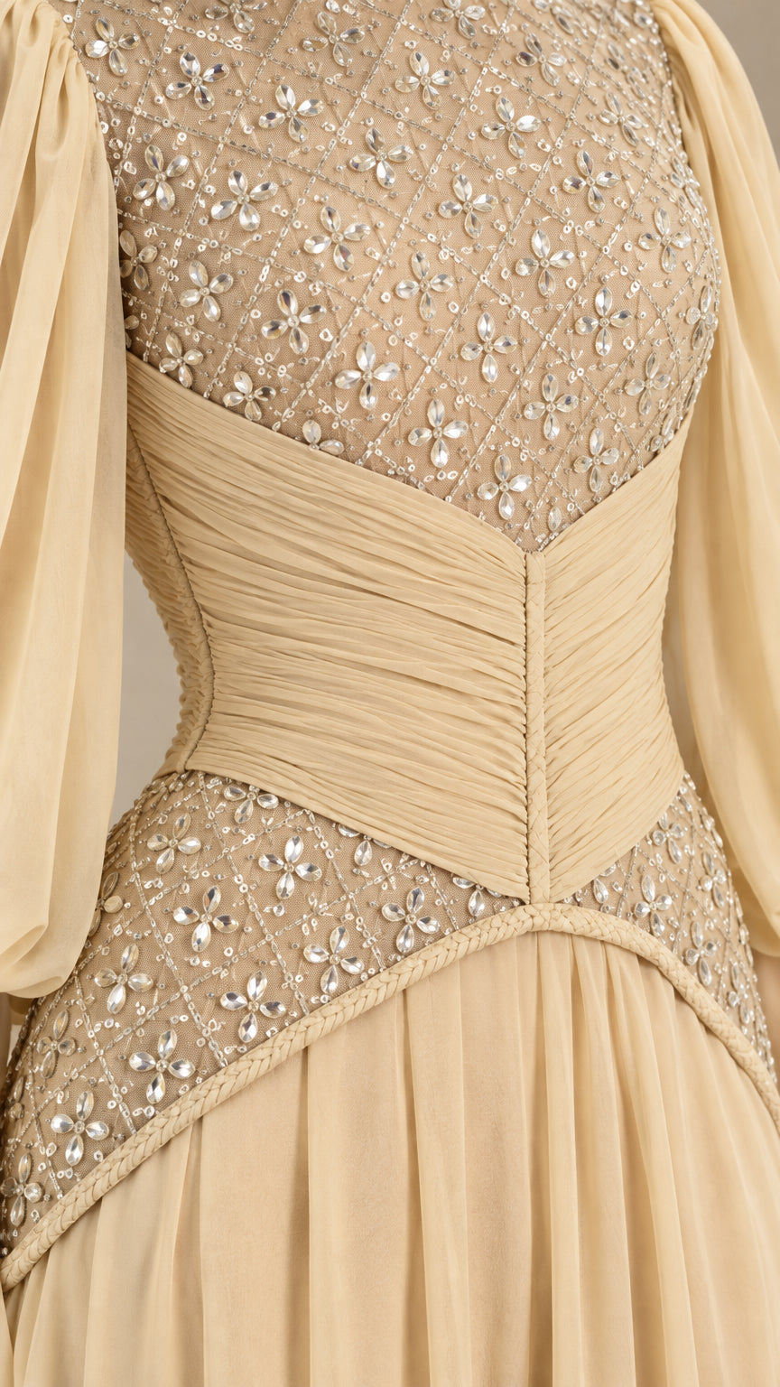 Close-up of beaded illusion bodice and ruched waist detail in champagne