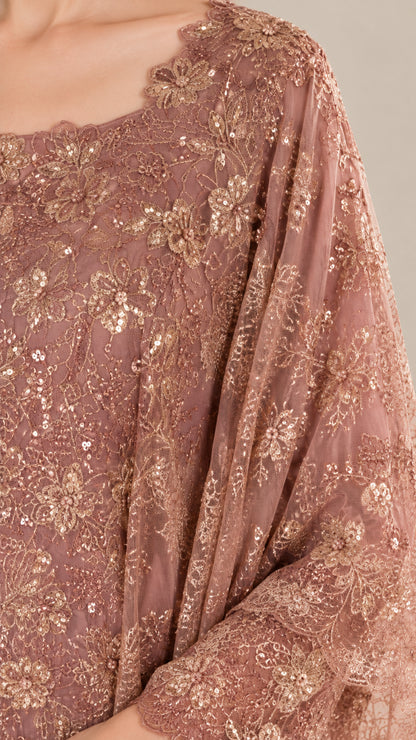 Close-up detail of scalloped neckline and intricate floral sequin embroidery on dusty rose gown