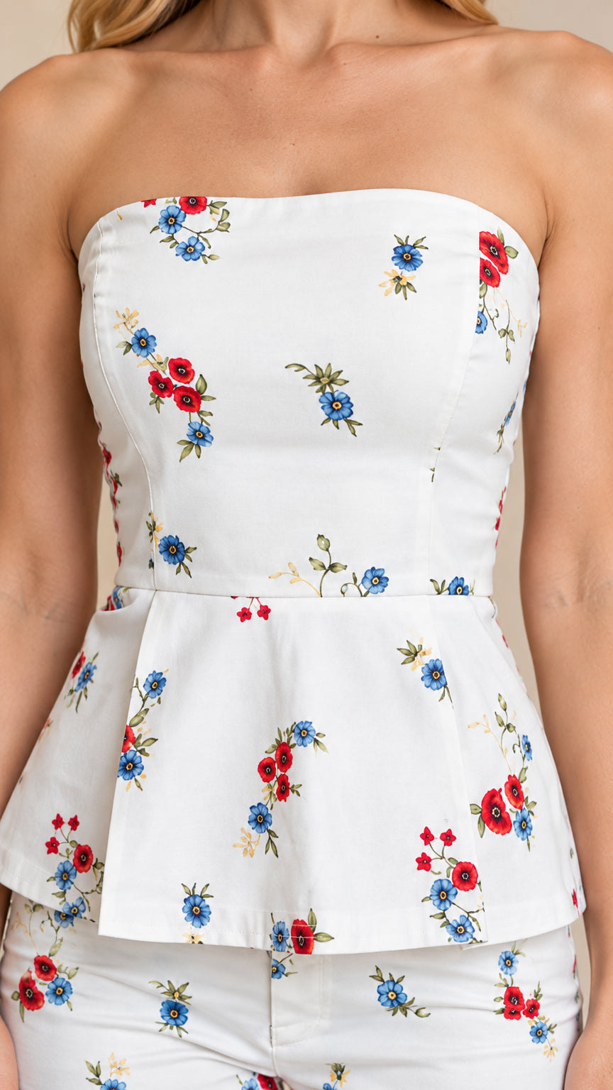 Close-up detail of strapless floral peplum top bodice and flared waist