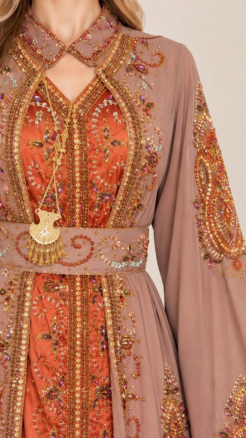 Close-up detail of ornate embroidery and neckline on dusty rose kaftan