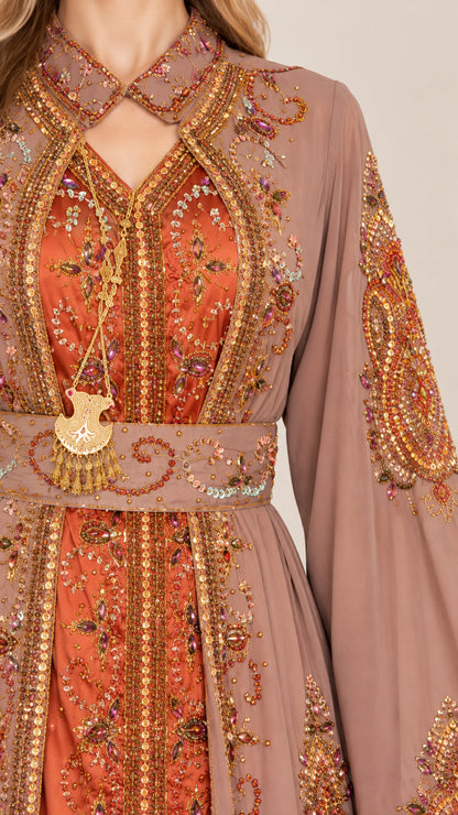 Close-up detail of ornate embroidery and neckline on dusty rose kaftan