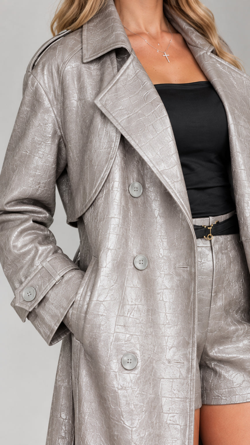 Close-up detail of textured croc-embossed faux leather lapel and button closure