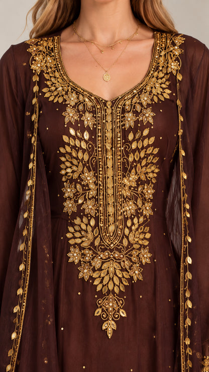 Close-up detail of ornate gold embroidery on chocolate brown kaftan bodice and neckline