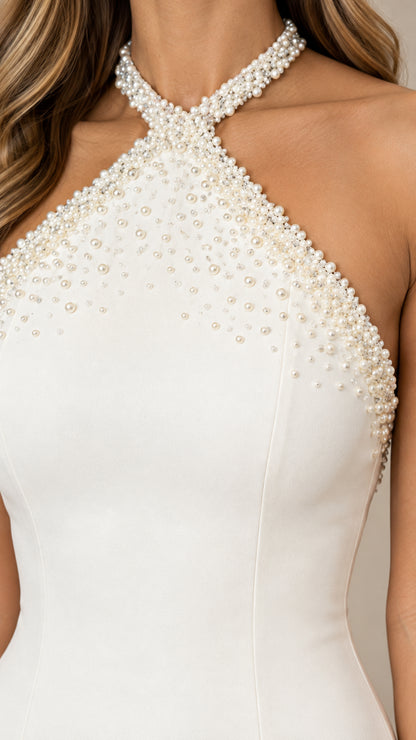 Close-up of intricate pearl beaded halter neckline on white dress