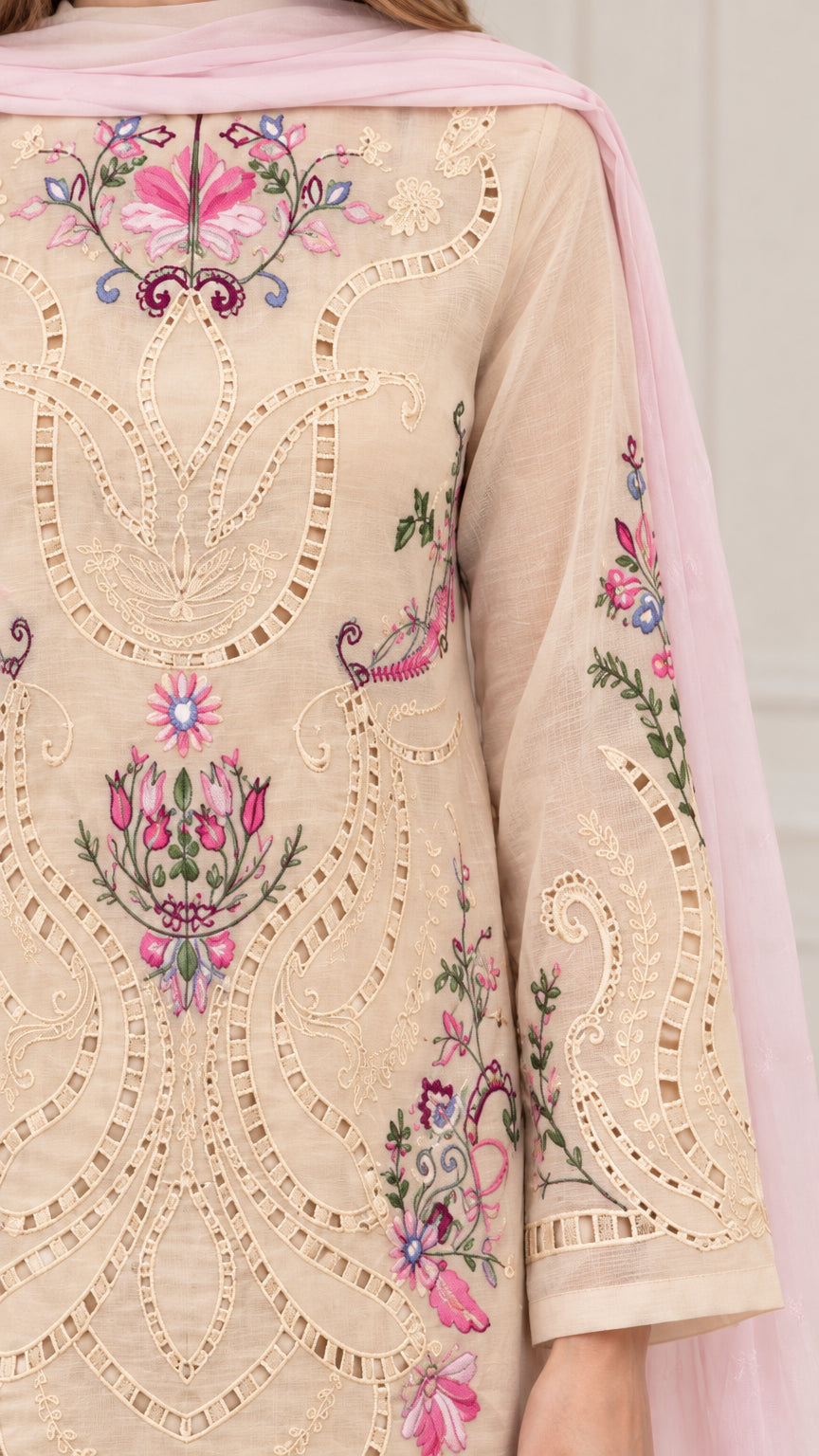 Close-up detail of intricate floral embroidery and cutwork on beige tunic