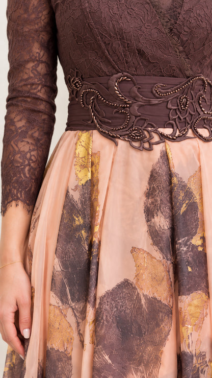 Close-up detail of lace sleeve, beaded waist applique, and printed skirt fabric