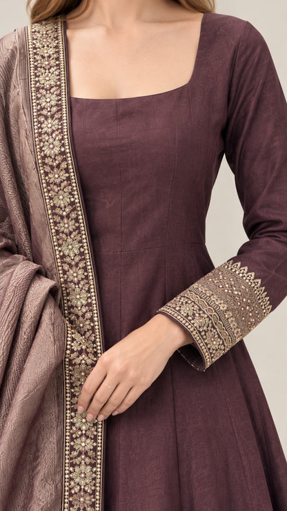 Close-up of square neckline and gold embroidered sleeve cuffs on plum gown