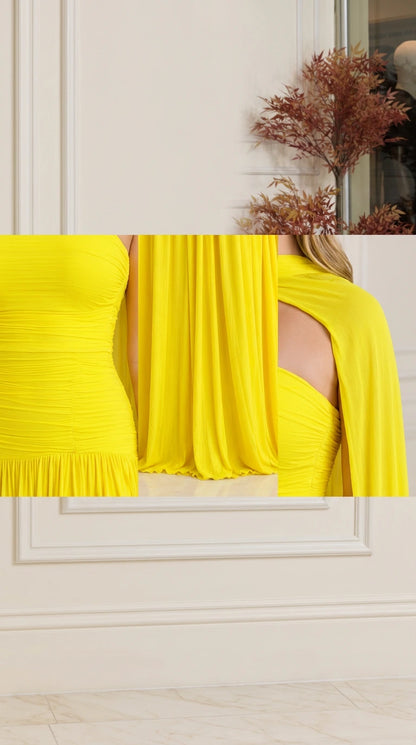 Close-up detail of fine bodice ruching and flowing cape fabric on yellow gown