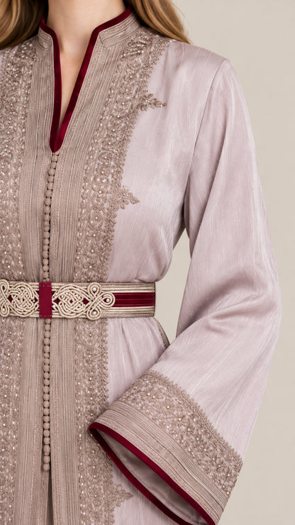 Close-up detail of ornate gold embroidery, contrast trim, and belt on dusty lilac kaftan