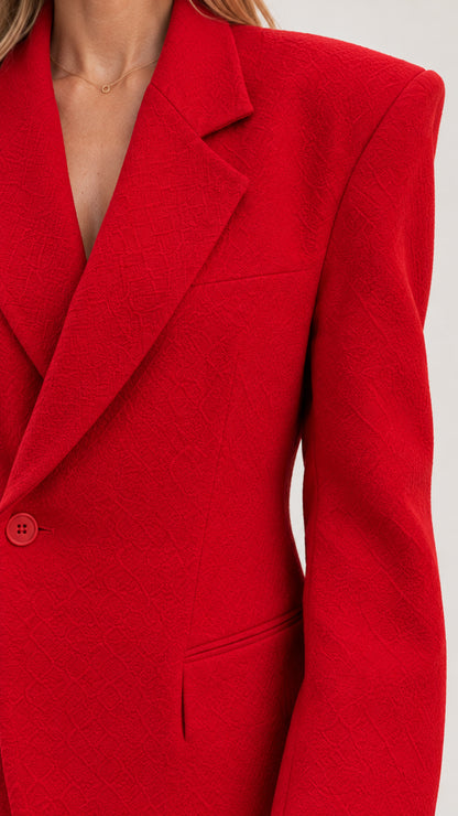 Close up of textured fabric and lapel details on red blazer dress