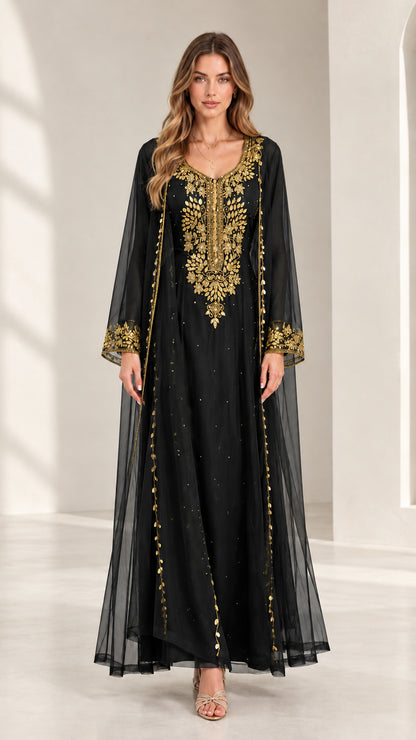 Front view of woman wearing black embroidered kaftan maxi dress with gold accents