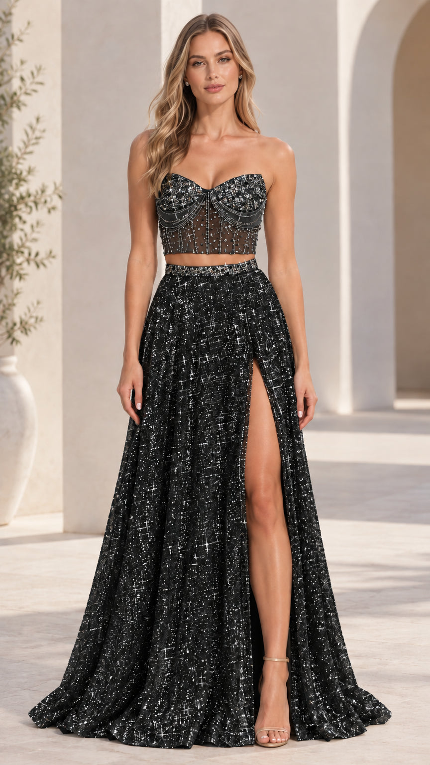 Model wearing black two-piece embellished corset evening gown with high leg slit