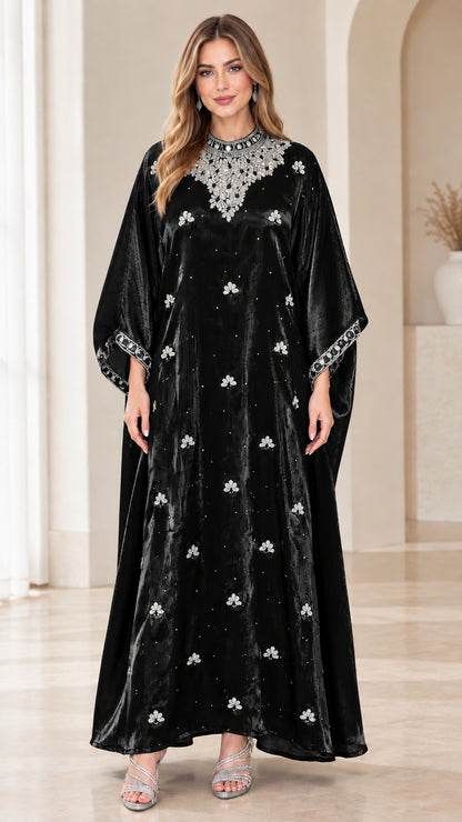 Model wearing black velvet kaftan maxi dress with crystal neckline embellishments
