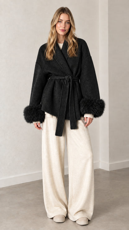 Front view of black belted wrap coat with matching black faux fur cuffs