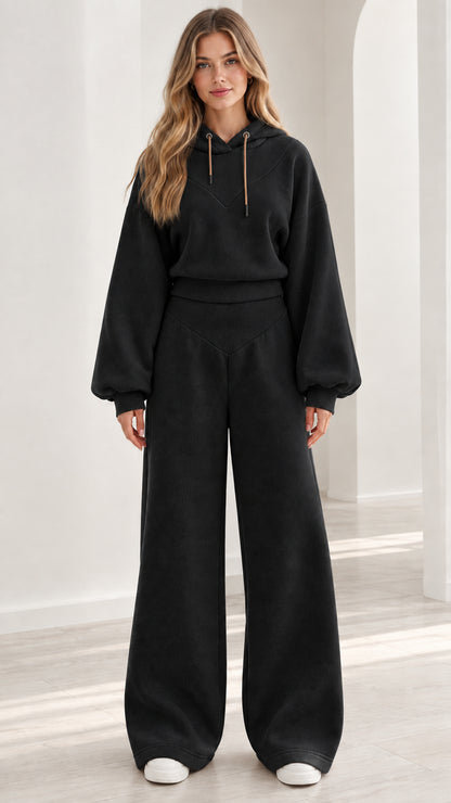 Model wearing black 2-piece fleece hoodie and wide-leg sweatpants set