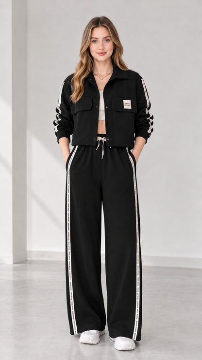 Full view of women's cropped jacket and wide-leg track pants set in black