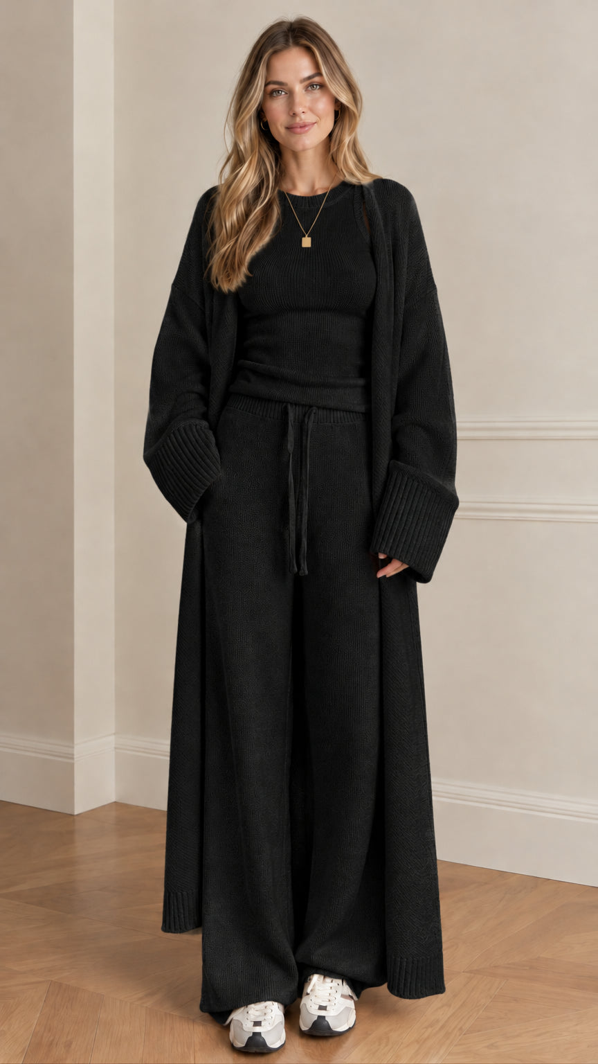 Front view of woman wearing black 3-piece knit lounge set with maxi cardigan