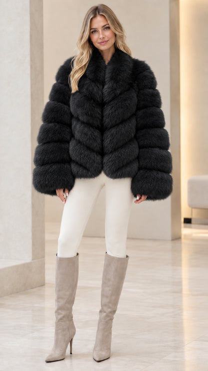 Model wearing black ribbed faux fur jacket with white pants and high-heel boots