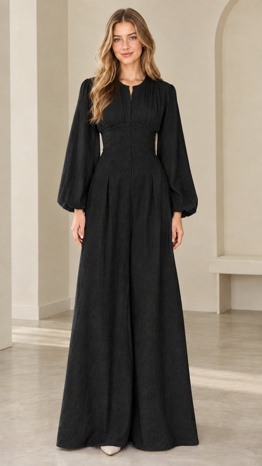 Model wearing black lantern sleeve wide leg evening jumpsuit