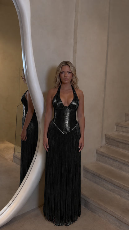 Front view of model wearing black halter corset fringe maxi dress
