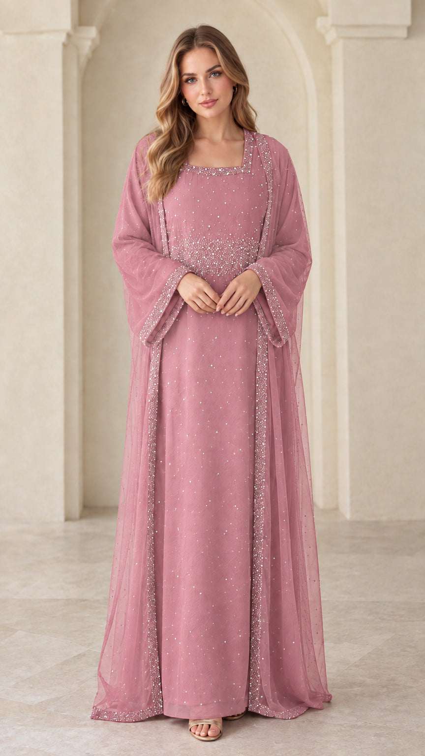 Front view of model wearing dusty pink beaded layered evening maxi dress