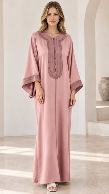 Full-length view of woman wearing dusty pink embroidered kaftan maxi dress