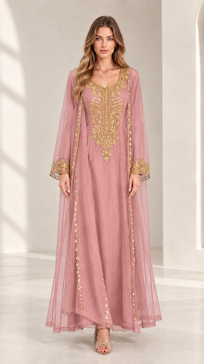 Front view of woman wearing dusty rose embroidered kaftan maxi dress with gold accents