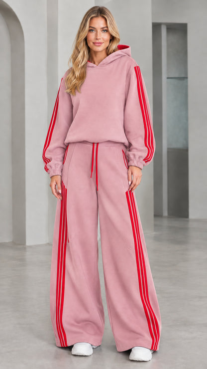 Front view of woman wearing dusty pink 2-piece wide leg tracksuit set with red stripes