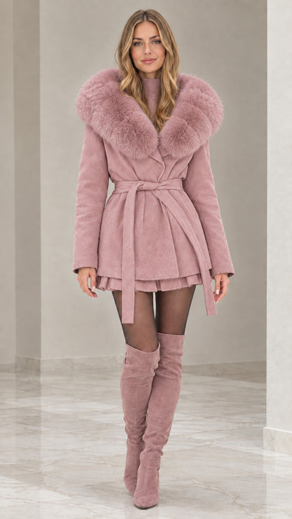 Front view of model wearing dusty pink faux fur hooded belted coat with matching pink boots